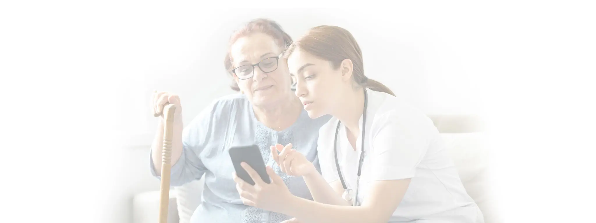 Caregiver helping client look at information on a phone