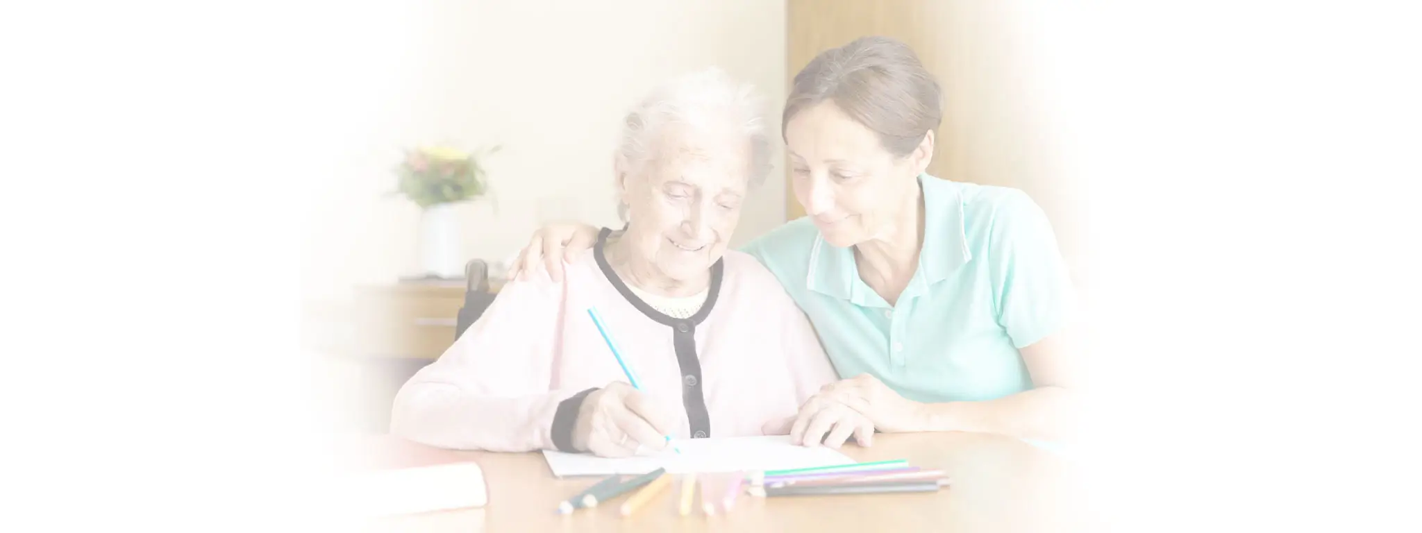 Caregiver helps client with a creative project